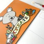 Front detail of create Koala 72 Bumblebee Lane postcard